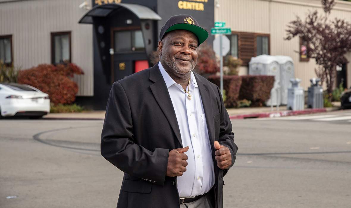Dorsey Nunn, standing outside, smiling and giving the thumbs up.